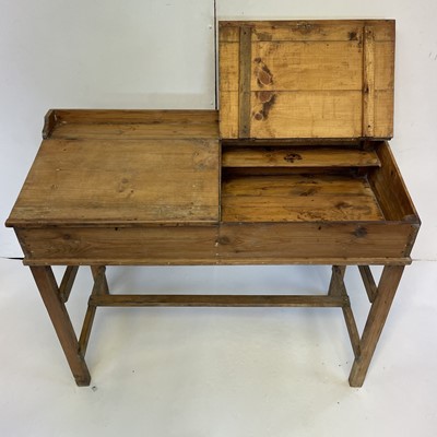 Lot 3117 - A pine clerk's desk, with two sloping lift-up...