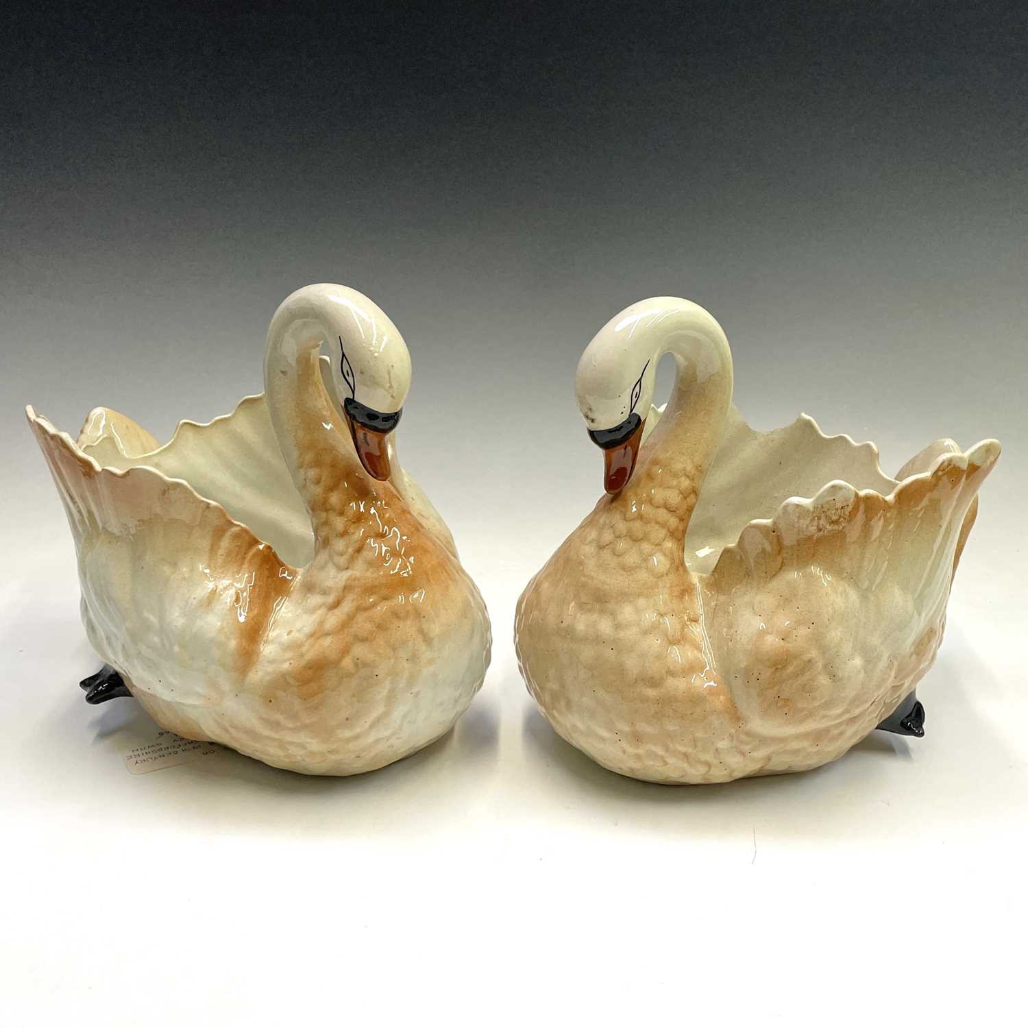 Lot 941 - A pair of Staffordshire pottery swan