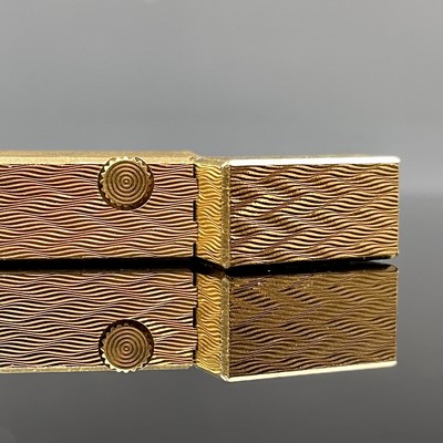 Lot 214 - A Dunhill gold plated engine turned lighter.