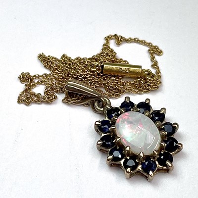 Lot 672 - A 9ct opal and sapphire cluster pendant...