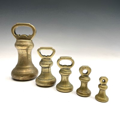 Lot 31 - A set of five Victorian brass bell weights.