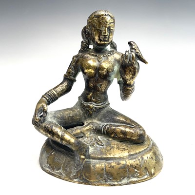 Lot 1035 - An Indian bronze figure of a seated lady...