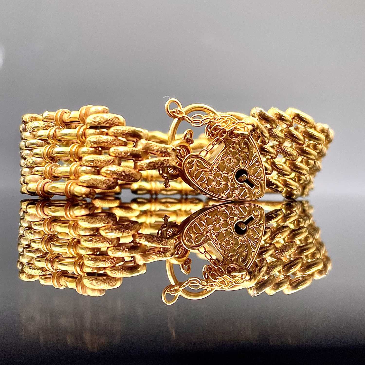 Lot 687 - A 9ct gold fancy gatelink bracelet with...