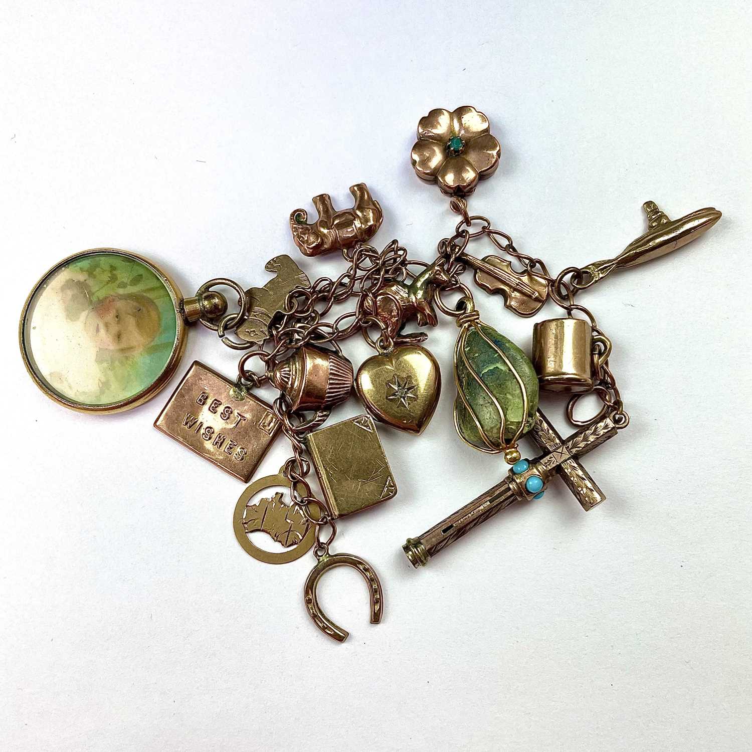 Lot 734 - A 9ct gold charm bracelet with 16 gold charms...