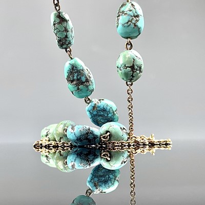 Lot 660 - A gold and turquoise necklace, length 40cm.