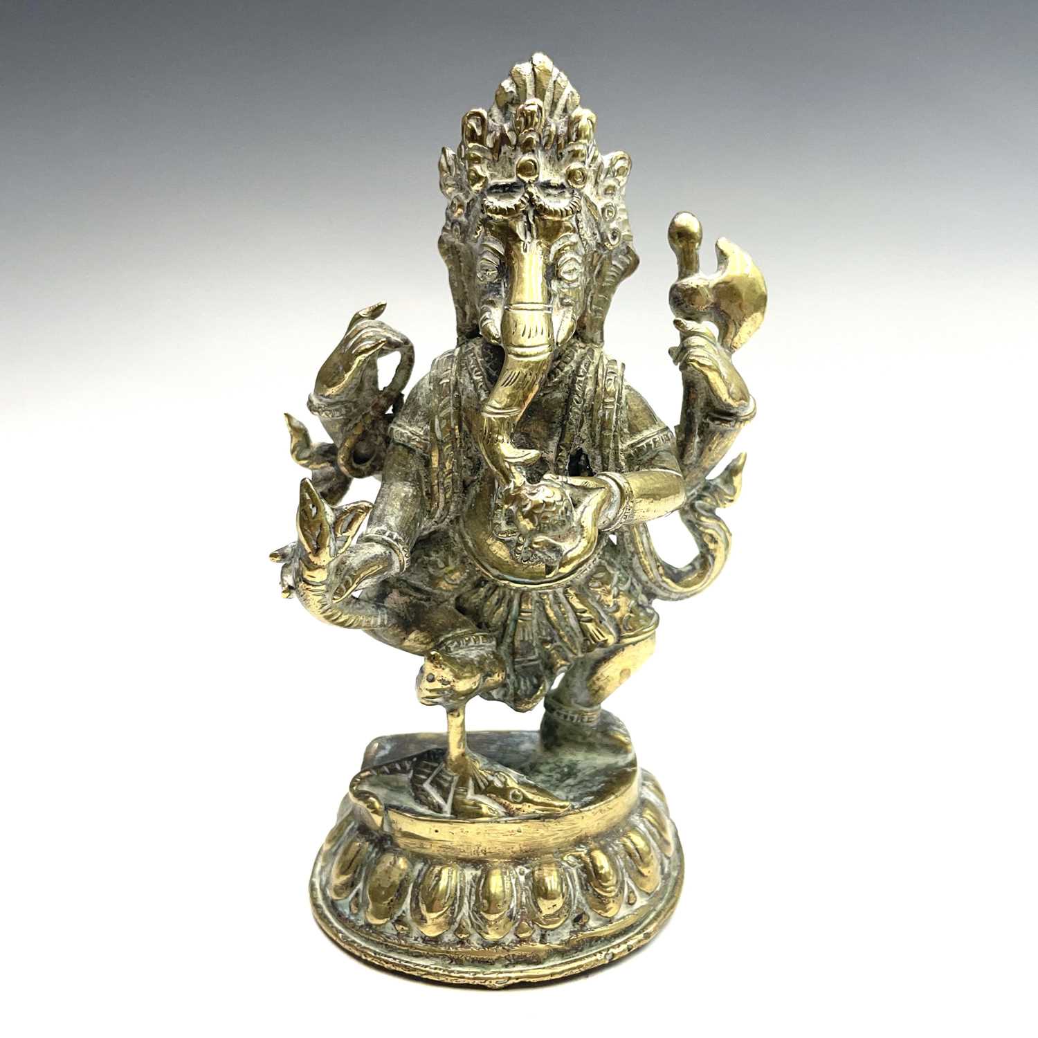 Lot 1037 - An Indian brass figure of Ganesha, early 20th...