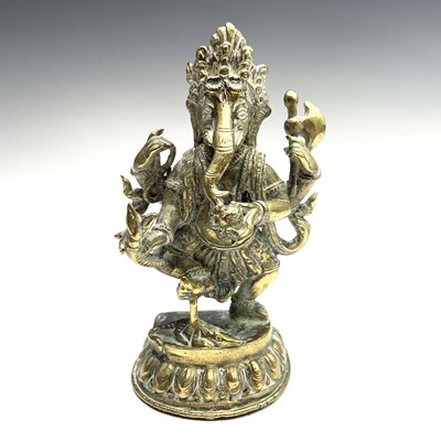 Lot 1037 - An Indian brass figure of Ganesha, early 20th...