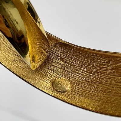 Lot 279 - An Alexis Kirk gilt metal and black enamel hinged choker.