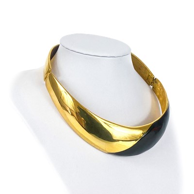 Lot 279 - An Alexis Kirk gilt metal and black enamel hinged choker.