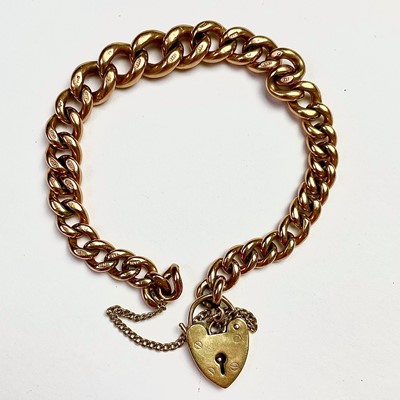 Lot 859 - A 9ct gold curblink bracelet with padlock...