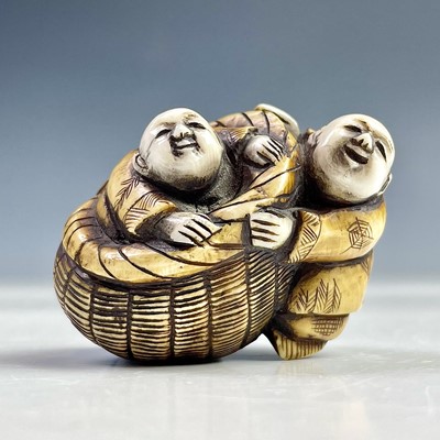 Lot 566 - A Japanese ivory netsuke of two figures and a...