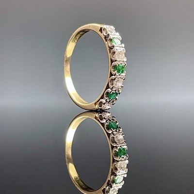 Lot 885 - An 18ct hallmarked gold emerald and diamond...