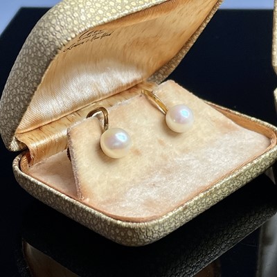 Lot 714 - A pair of 14k gold pearl set screw earrings by...
