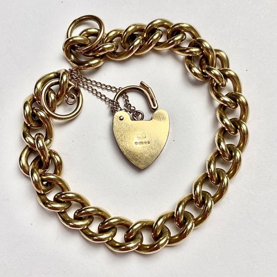 Lot 785 - A 9ct gold curb link bracelet with padlock...