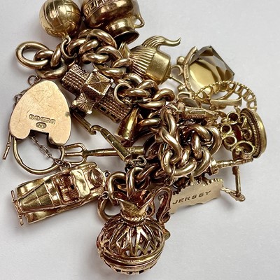 Lot 755 - A 9ct gold charm bracelet with 18 various...