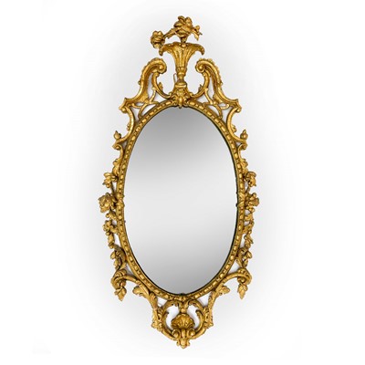 Lot 3122 - An 18th century oval carved gilt wall mirror,...