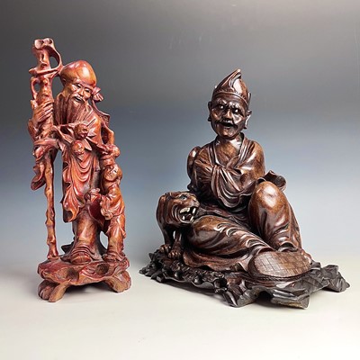 Lot 104 - A Chinese hardwood carved figure of a man with a tiger, 19th century.