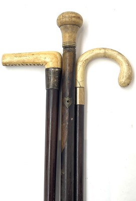 Lot 231 - An 18th century ebony cane, with turned ivory...