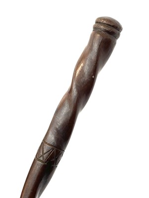 Lot 168 - A primitive chip carved hardwood walking stick,...