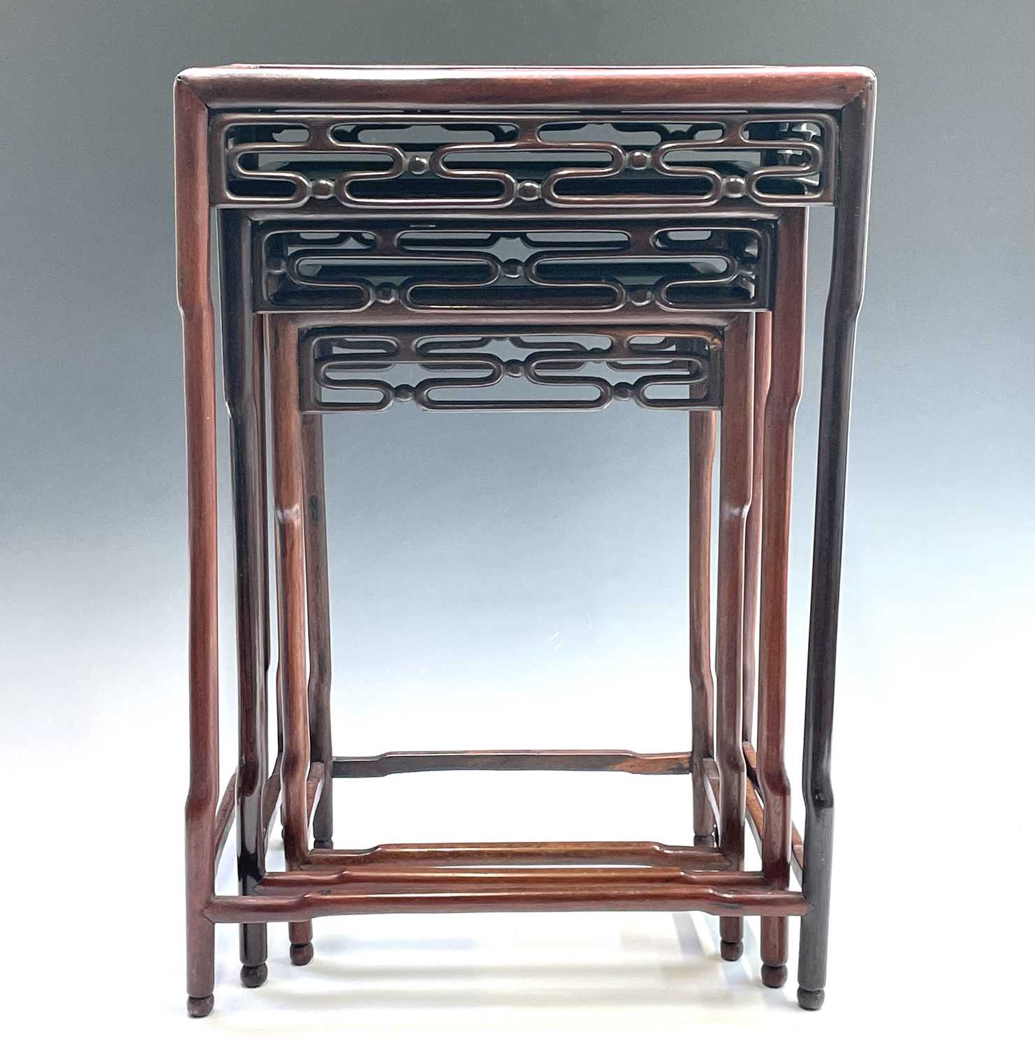 Lot 351 A Chinese hardwood nest of three tables,