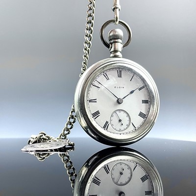 Lot 985 - An Elgin silver crown wind pocket watch, the...