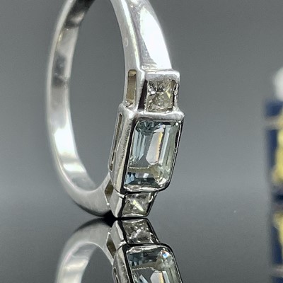 Lot 794 - A 9ct white gold diamond and aquamarine three...