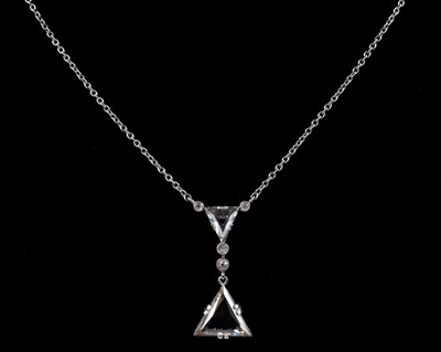 Lot 139 - An early 20th century white gold diamond pendant necklace set with two triangle cut diamonds.