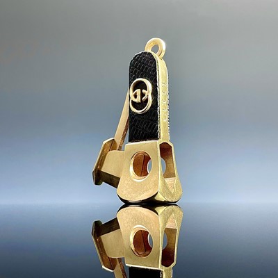 Lot 1041 - A Gucci gold plated and leather cigar cutter,...