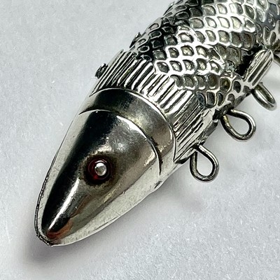 Lot 902 - An silver articulated fish; together with a...
