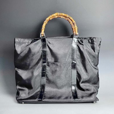 Lot 1042 - A Gucci tote bag, with black patent leather...