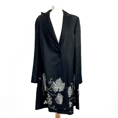 Lot 566 - Alexander McQueen, a black mixed cotton long coat with silver fruiting grape vine detail.