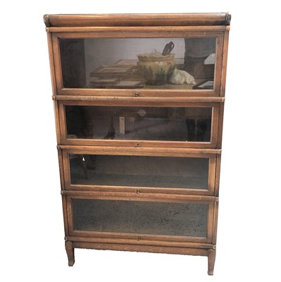 Lot 3198 - An oak sectional bookcase, with four glazed...