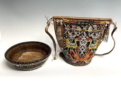 Lot 430 - A Dayak baby carrier, Borneo, the woven cane...