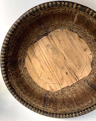 Lot 430 - A Dayak baby carrier, Borneo, the woven cane...