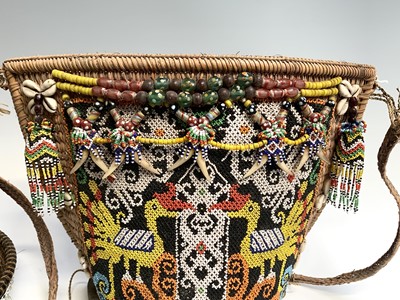 Lot 430 - A Dayak baby carrier, Borneo, the woven cane...