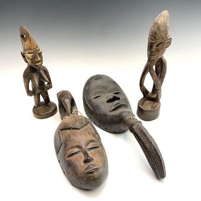 Lot 373 - An African wood carved mask together with...