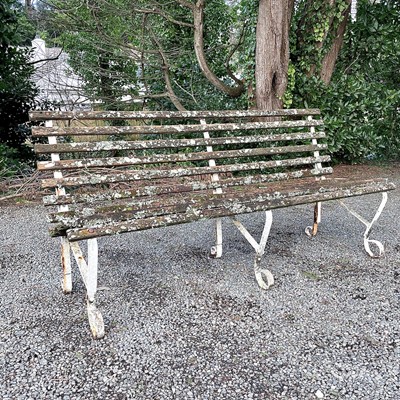 Lot 609 - A wrought iron and slatted bench originally...