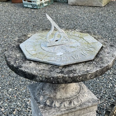 Lot 614 - A cast metal sundial on a square reconstituted...