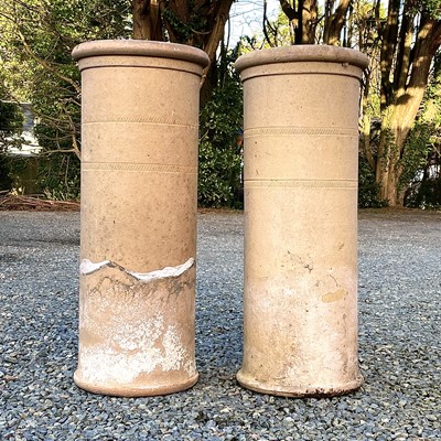 Lot 626 - A pair of stoneware chimney pots, incised band...