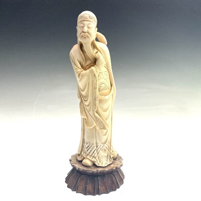 Lot 437 - A Chinese ivory figure of a Lohan holding a...