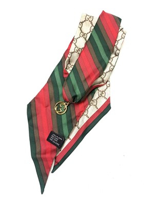 Lot 1065 - Gucci silk choker Silk scarf choker in reds...