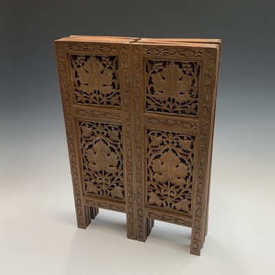 Lot 1054 - An Indian carved wood folding occasional table,...