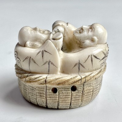 Lot 554 - A Japanese ivory netsuke of two figures with a...