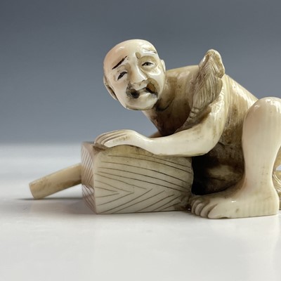 Lot 558 - A Japanese ivory netsuke of a rat catcher,...
