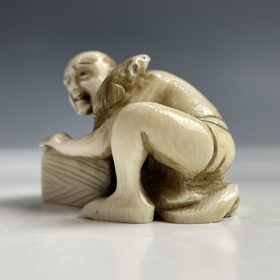 Lot 558 - A Japanese ivory netsuke of a rat catcher,...