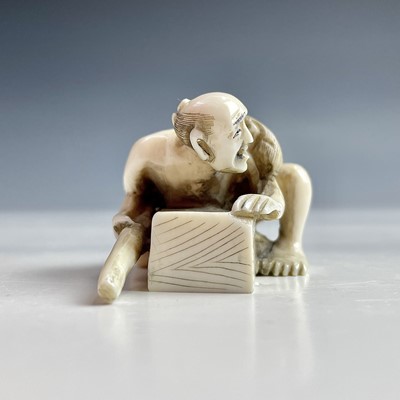 Lot 558 - A Japanese ivory netsuke of a rat catcher,...