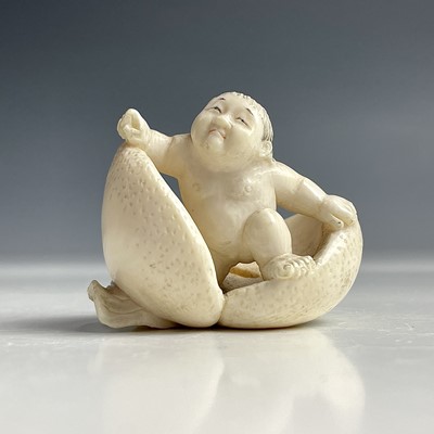 Lot 559 - A Japanese ivory netsuke of Momotaro the peach...