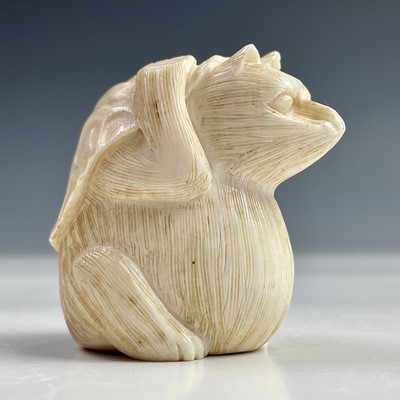 Lot 565 - A Japanese ivory netsuke of a possum beneath a...