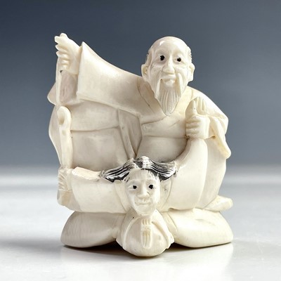 Lot 567 - A Japanese ivory netsuke group, early 20th...