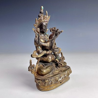 Lot 490 - A Sino-Tibetan gilt bronze figure of a...